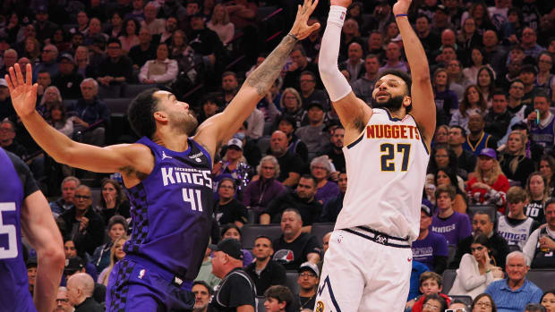Feb 9, 2024; Sacramento, California, USA; Denver Nuggets guard Jamal Murray (27) shoots the ball against Sacramento Kings forward Trey Lyles (41) during the second quarter at Golden 1 Center. Mandatory Credit: Kelley L Cox-USA TODAY Sports  